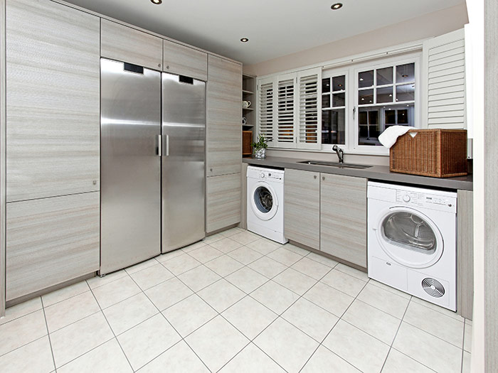 modern kitchen with washing machine and tumble dryer